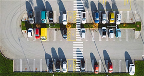 overhead view of a parking lot with cars in it